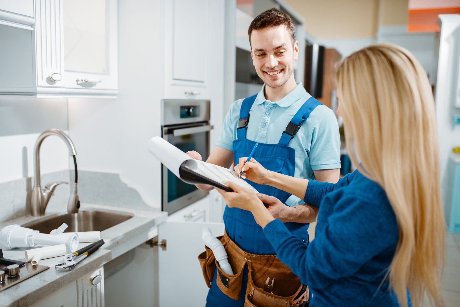 HydraGen technician consulting with customer in kitchen