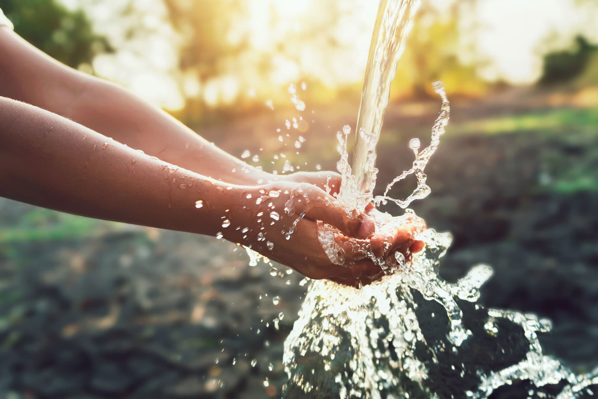 Clean water flowing into hands during water quality testing