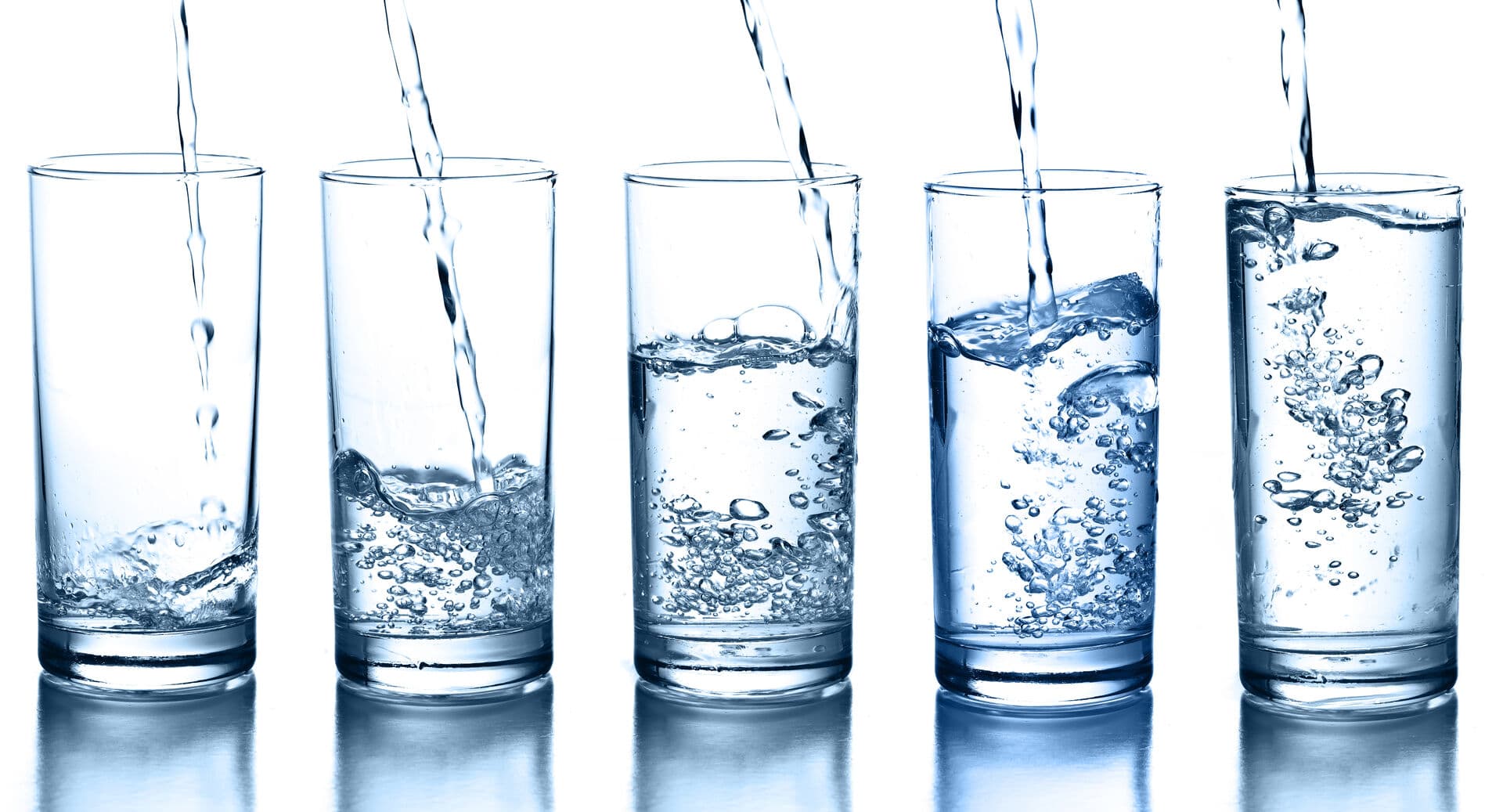 Woman enjoying clean water in a modern kitchen