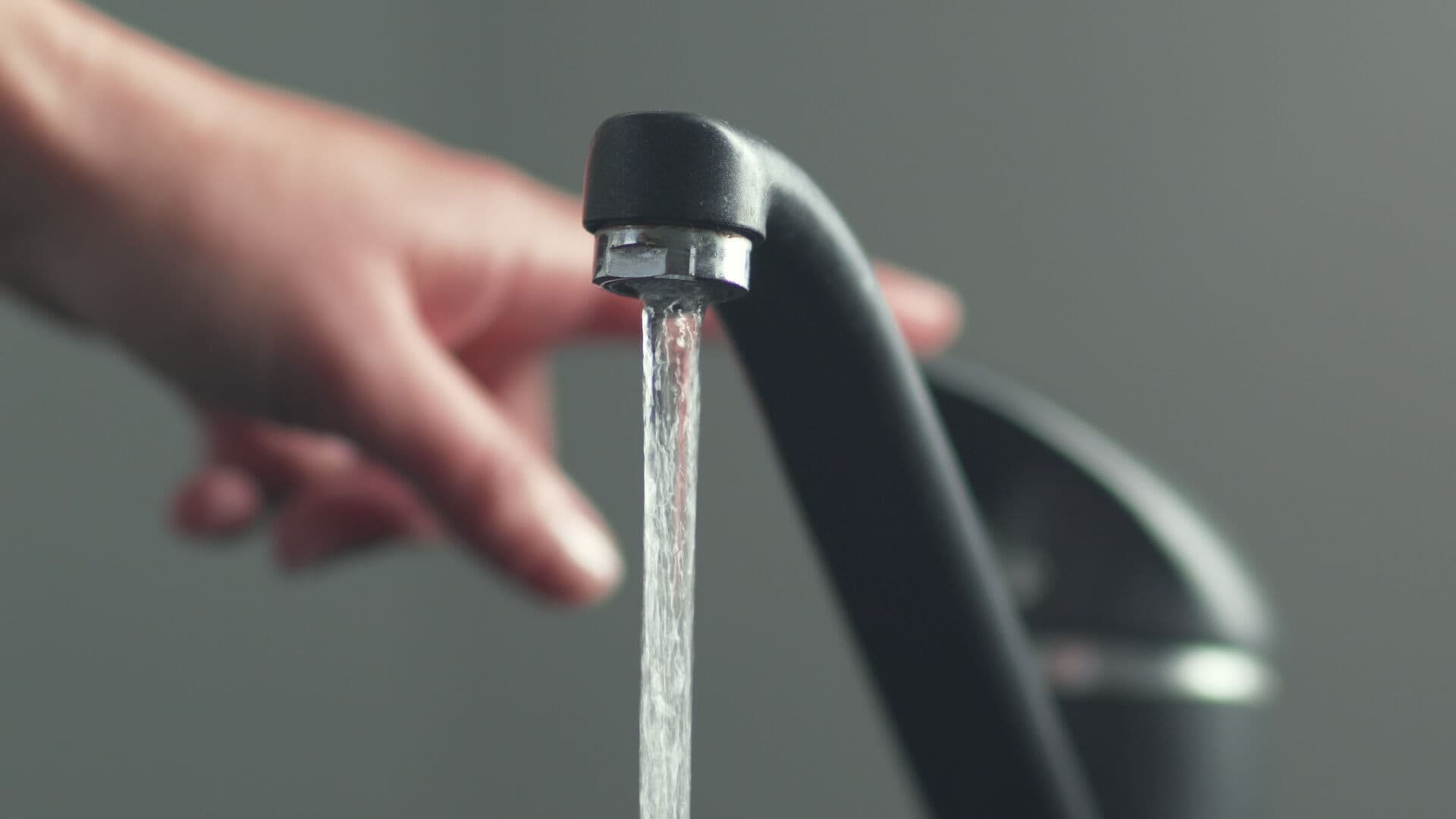 Clean water flowing from a kitchen faucet